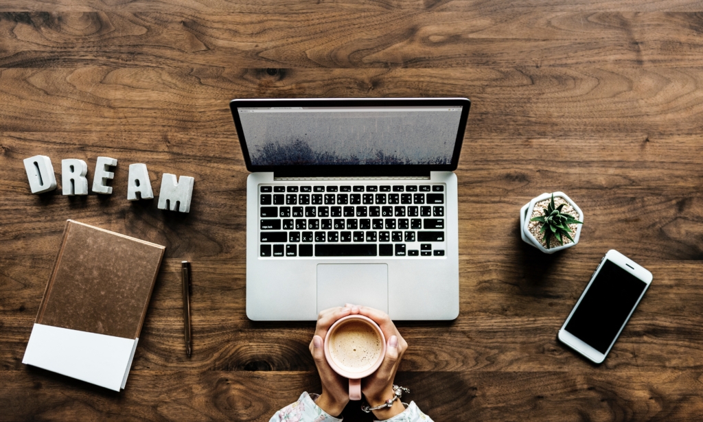 Table with a laptop and a coffee cup