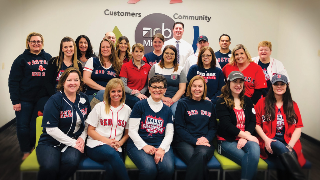 Group photo of Country Bank staff supporting the Jimmy Fund Rally Against Cancer event by wearing Red Sox gear.