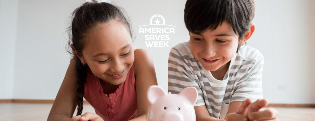 Two kids laying on the floor looking at a piggy bank with the text 'America Saves Week'