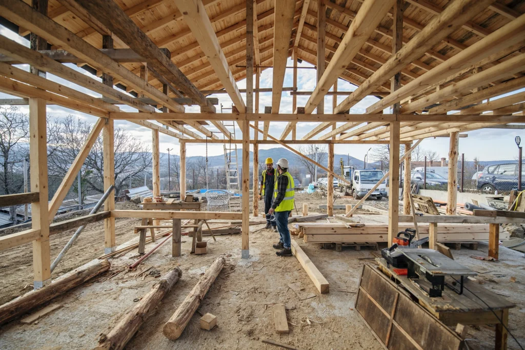 Country-Bank-construction-workers-stand-underneath-roof-timbers