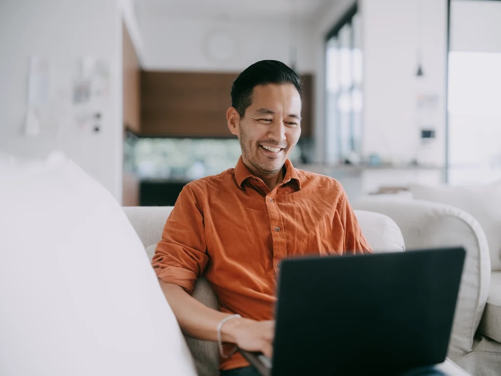 Country-Bank-man-sitting-at-chair-with-computer-sending-a-wire-transfer