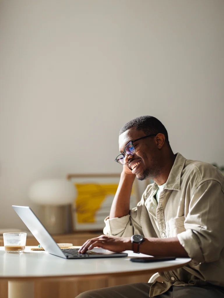 Country-Bank-man-sitting-at-desk-making-loan-payment-from-computer