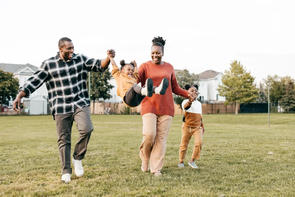 Country-Bank-mom-dad-children-walking-swinging-youngest-child