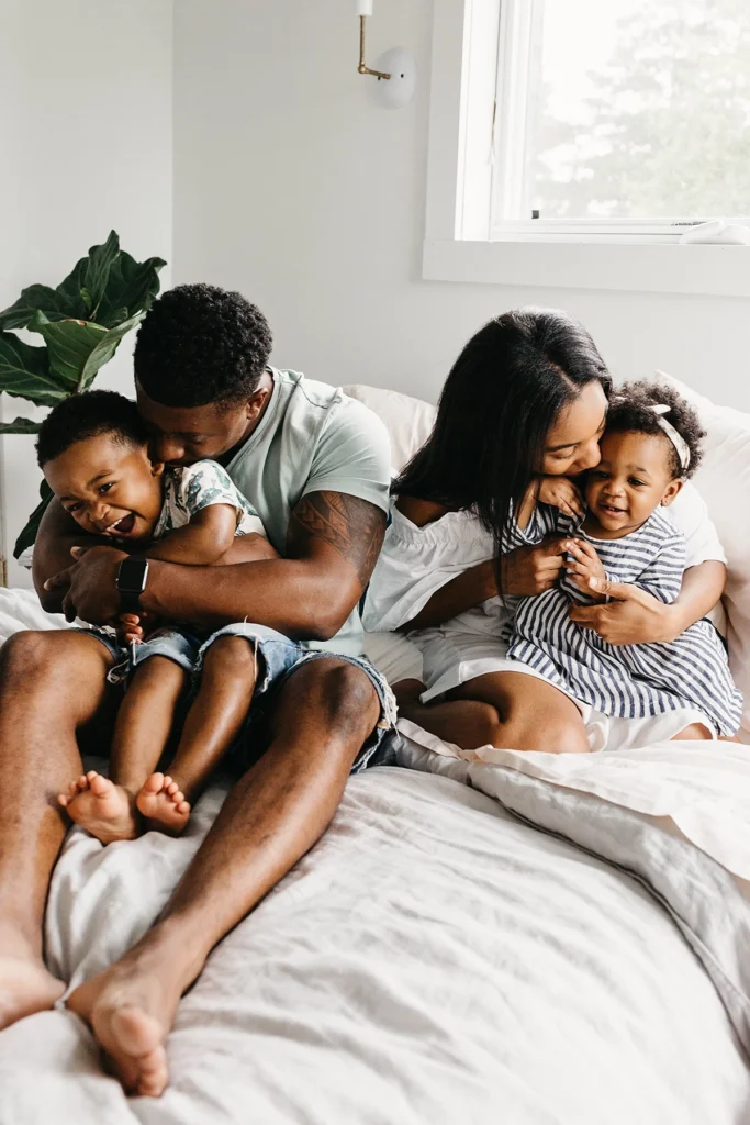 Country-Bank-mom-dad-two-children-on-couch-cuddling-and-happy
