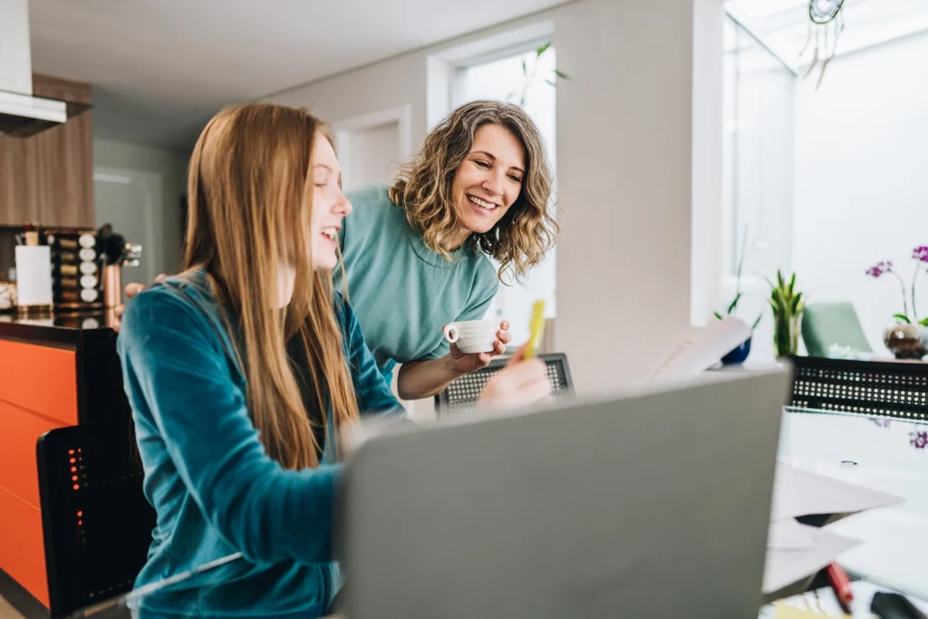 Country-Bank-mother-daughter-open-bank-acount-online-at-kitchen-table
