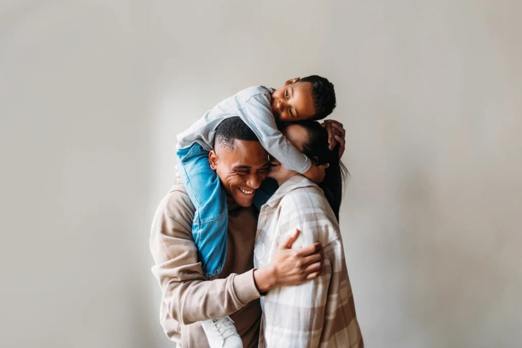 Country-Bank-mother-father-young-son-hugging-on-each-other.