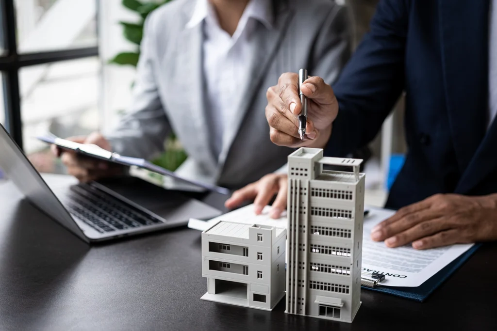 Country-Bank-professionals-at-desk-with-model-highrise