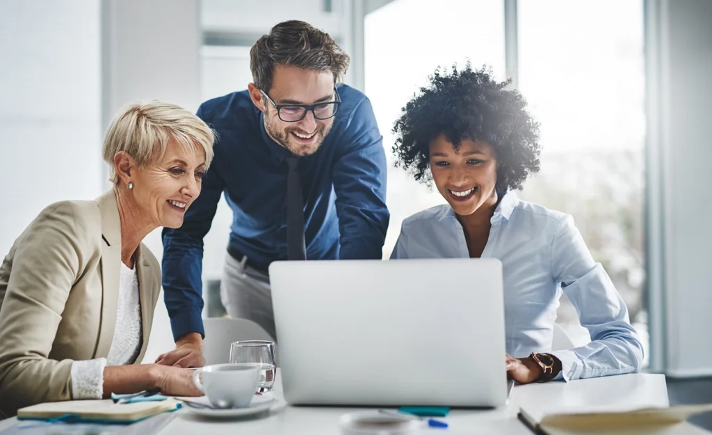 Country-Bank-three-coworkers-sitting-at-table-looking-into-computer-screen