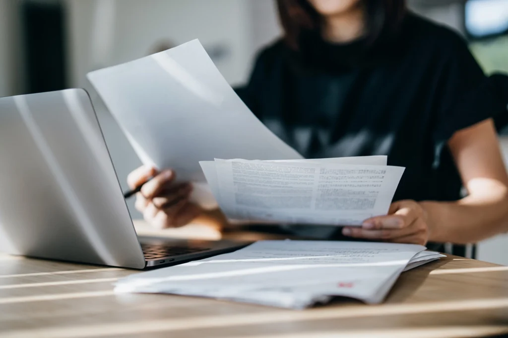 Country-Bank-woman-at-office-in-front-of-computer-examining-bank-account-statements