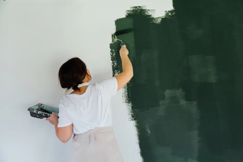 Country-Bank-woman-painting-a-wall-in-her-home-green